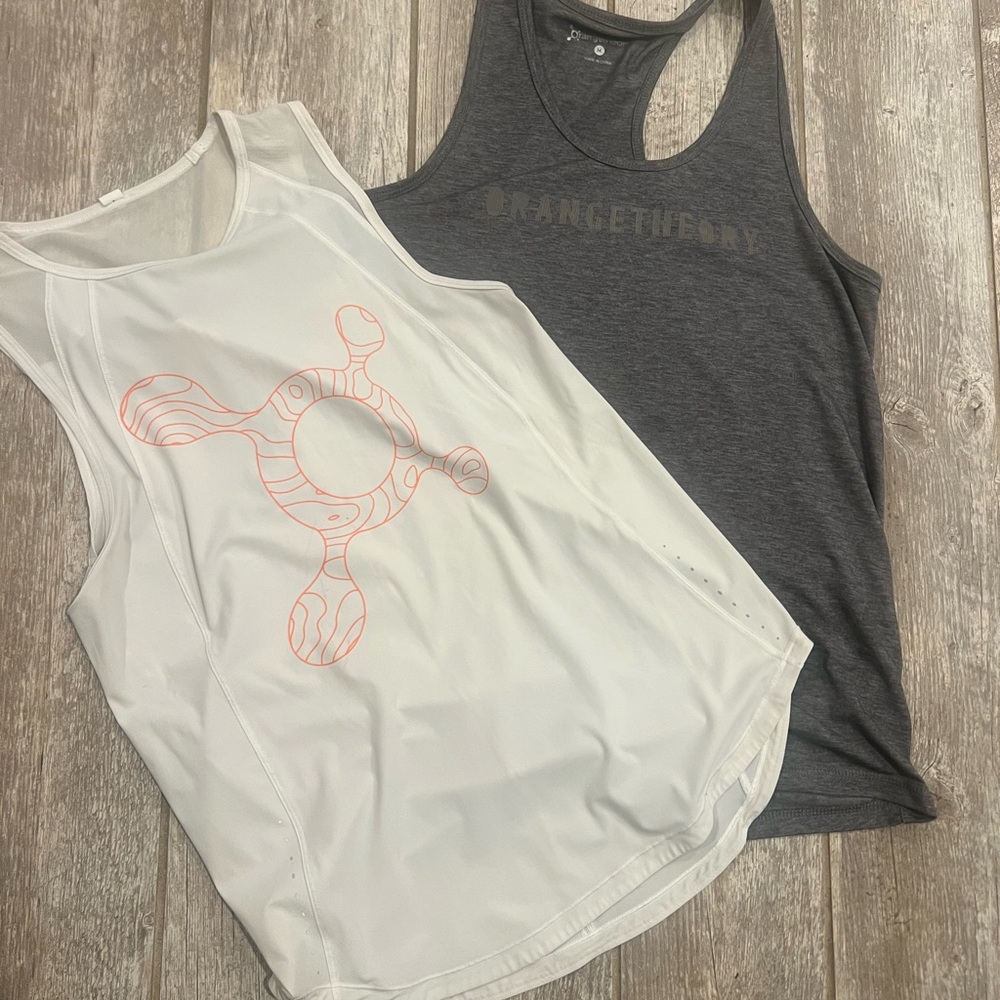 Lululemon Orange Theory White Tank Top and Grey Orange Theory tank.